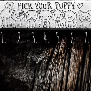 May include: A rectangular wooden sign with the text "PICK YOUR PUPPY" and seven cartoon dog illustrations. Each dog has a unique design. Numbers 1 through 7 are below the dogs. The sign is in black and white.