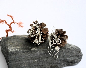 Asymmetric designer earrings in woven sterling silver