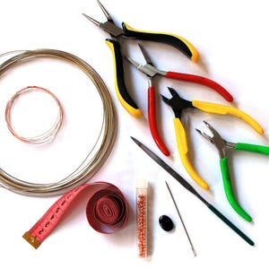 May include: A set of jewelry making tools including wire cutters, pliers, a needle, a measuring tape, a spool of wire, and a small container of beads.