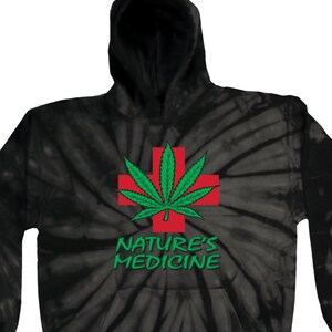 May include: Black tie-dye hoodie with a green marijuana leaf and red cross graphic. The text "Nature's Medicine" is printed below the graphic.