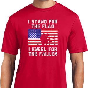May include: Red t-shirt with a distressed American flag graphic and the text "I stand for the flag I kneel for the fallen".