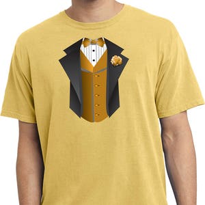 May include: A yellow t-shirt with a graphic of a tuxedo, featuring a black jacket, a gold vest, a white bow tie, and a gold flower.