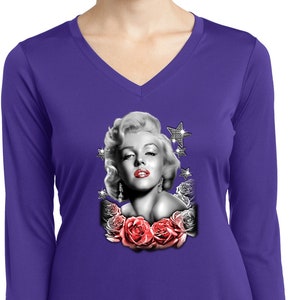 May include: Purple long-sleeved shirt with a black and white image of Marilyn Monroe with red lips and a diamond-studded star. The image is surrounded by red roses.