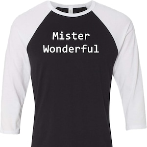 May include: A black and white baseball tee shirt with the text "Mister Wonderful" printed on the front.
