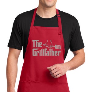 May include: Red apron with two pockets and adjustable neck straps. The apron has the text "The Grillfather" with a hand holding a spatula.