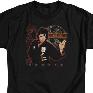 May include: Black t-shirt with a graphic of Elvis Presley in a karate pose, with the text "Elvis" and "Karate" printed on the shirt.