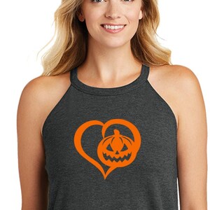 May include: A dark grey tank top with a bright orange heart and pumpkin design. The heart is outlined and the pumpkin has a jack-o'-lantern face.