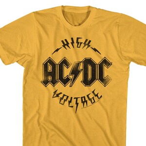 May include: A yellow t-shirt with a black graphic of the band AC/DC. The graphic features the band's name in bold letters with a lightning bolt and the words "High Voltage" in a circle around the band's name.