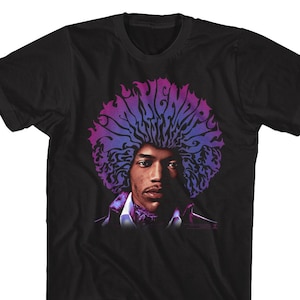 May include: Black t-shirt featuring a purple and blue graphic of Jimi Hendrix's face and hair with the text "Jimi Hendrix" in a stylised font.