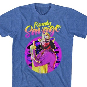May include: A blue t-shirt with a graphic of Randy Savage in a pink and yellow color scheme. The text "Randy Savage" is printed in a yellow and pink gradient.