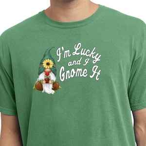 May include: A green t-shirt with a white graphic of a gnome holding a red pot and the text "I'm Lucky and I Gnome It".