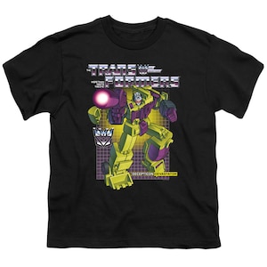 May include: Black t-shirt with a graphic of a green and purple robot with the text "The Transformers" and "More Than Meets The Eye" above the robot and "Decepticon Devastator" below the robot.