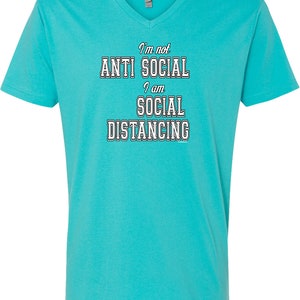 May include: A turquoise blue v-neck t-shirt with the text "I'm not anti social I am social distancing" in white outlined letters.