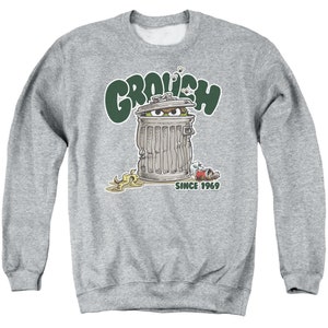 May include: A gray sweatshirt with a green "Grouchy" graphic. The graphic features a green monster peeking out of a trash can with the text "Since 1969".