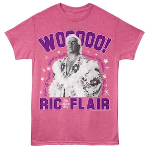 May include: Pink t-shirt with a purple graphic of Ric Flair, a professional wrestler, with the text "WOOO!" and "RIC FLAIR The Nature Boy".