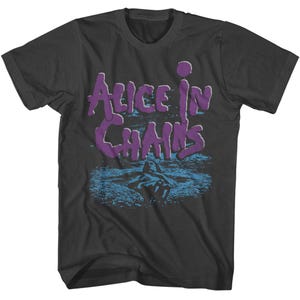 May include: Black t-shirt with a purple graphic of the band Alice in Chains. The graphic features the band's name in a stylized font and a blue and white image of a person swimming in water.