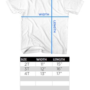 May include: White toddler short-sleeve t-shirt with sizing chart. The chart shows width and length measurements for sizes 2T, 3T, and 4T. Widths are 11", 12", and 13", and lengths are 15", 16", and 17".