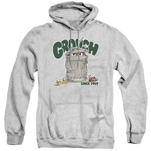 May include: Gray hooded sweatshirt with a green, white, and black illustration of Oscar the Grouch from Sesame Street. The illustration shows Oscar in a trash can with the text "Grouch" above him and "Since 1969" below him.