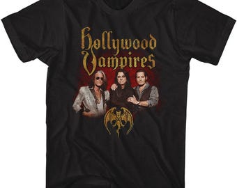 May include: Black t-shirt featuring a red, white and gold graphic of the band "Hollywood Vampires". The graphic includes the band's name, a bat and three band members.