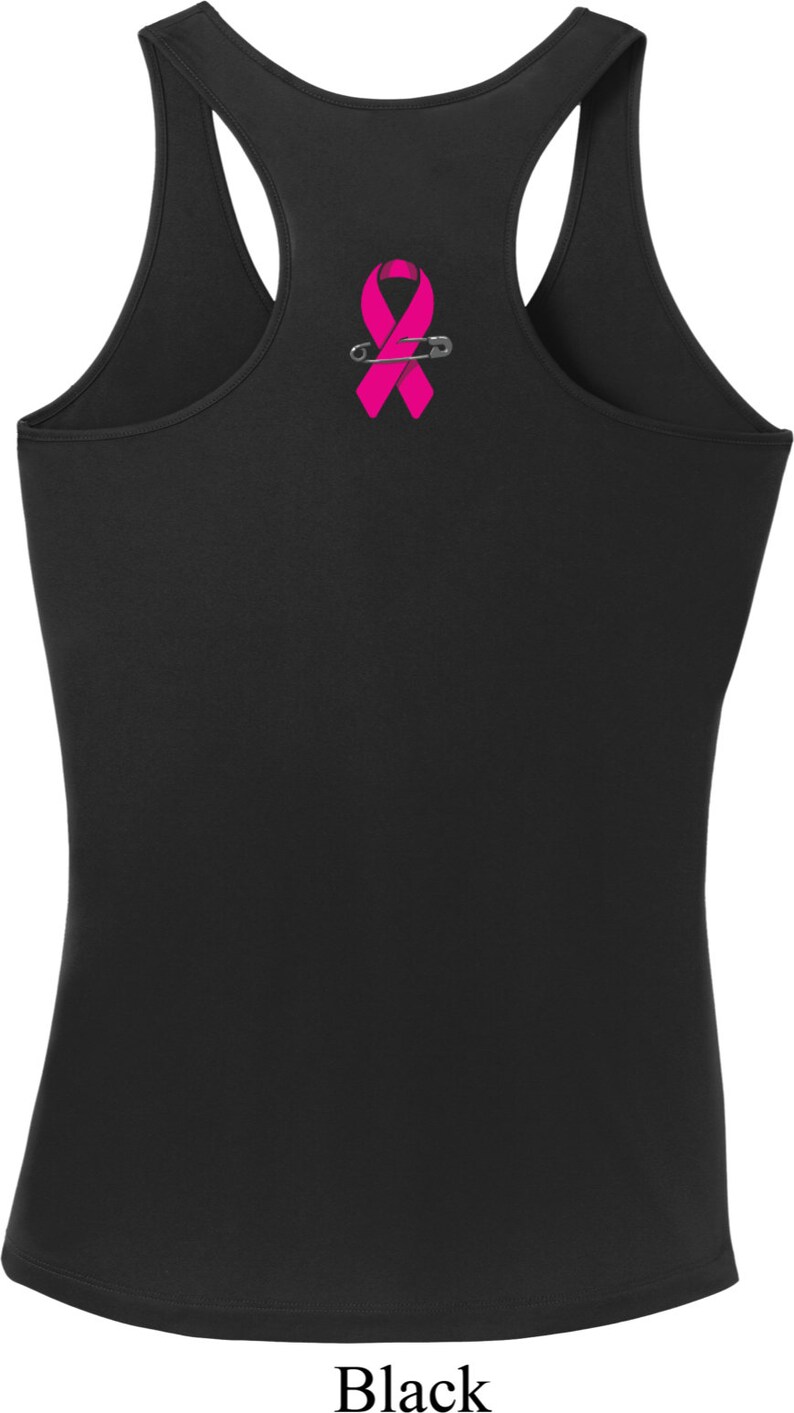 May include: Black tank top with a pink ribbon and safety pin graphic.