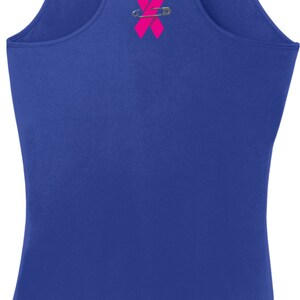 May include: Royal blue racerback tank top with a pink ribbon pinned to the back.