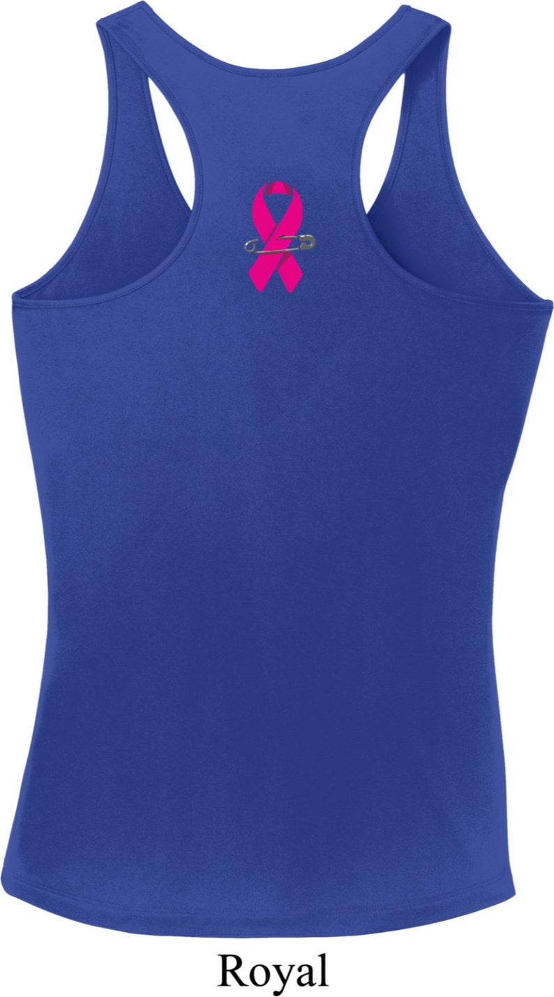 May include: Royal blue racerback tank top with a pink ribbon pinned to the back.