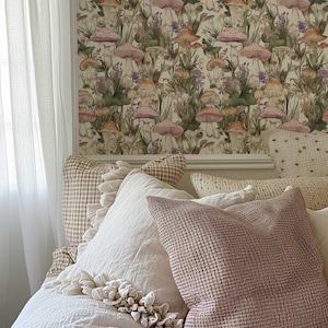 May include: A bedroom with a white bed and pillows. The wall behind the bed is covered in wallpaper with a mushroom and floral pattern.