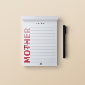 May include: A white notepad with lined pages, the word "MOTHER" in red, and "notes" in cursive. The name "Eleeta" is written in cursive. A black pen rests beside the notepad. A star logo is at the bottom.
