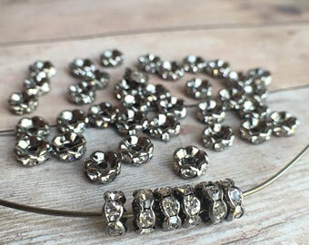 6mm AAA grade clear rhinestone crystals rondelle brass spacer, wavy edge, gun metal color brass, six crystals, 20 pieces