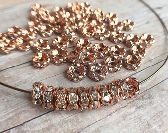 6mm AAA grade clear rhinestone crystal rondelle brass spacer, dark rose gold tone spacer, wavy edge, six crystals, 20 pieces