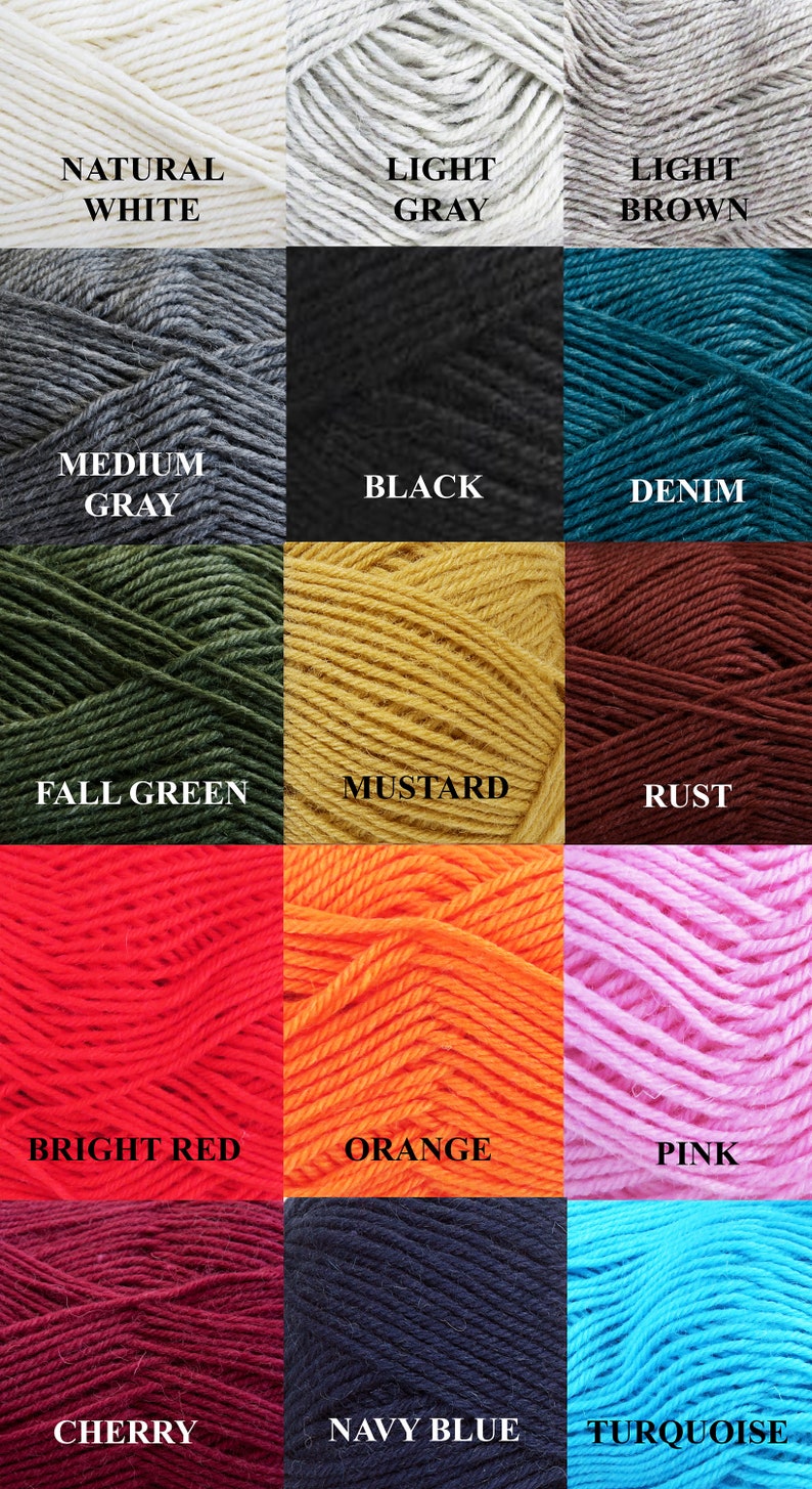 May include: A collection of yarn skeins in various colors, including natural white, light gray, light brown, medium gray, black, denim, fall green, mustard, rust, bright red, orange, pink, cherry, navy blue, and turquoise. Each skein has a label with the color name.