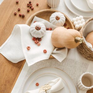 White natural linen table runner styled for a rustic farmhouse dining table