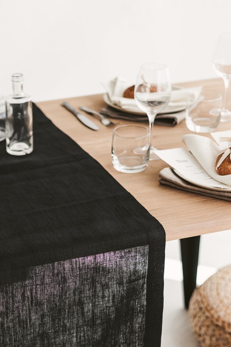 Sleek black linen table runner – perfect centerpiece for Halloween décor, holiday feasts, or an elegant wedding table. Made from sustainable, natural linen for long-lasting beauty. A luxurious and thoughtful gift for Christmas, birthdays, or new homeowners who love refined, modern home styling.