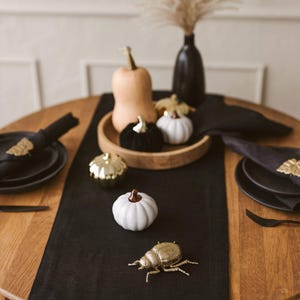 Elegant black natural linen table runner perfect for Halloween, Christmas, and Thanksgiving table settings. Adds a sophisticated, modern touch to weddings or formal dinners. A timeless and luxurious gift idea for housewarming or a new home, blending natural charm with bold, minimal style.