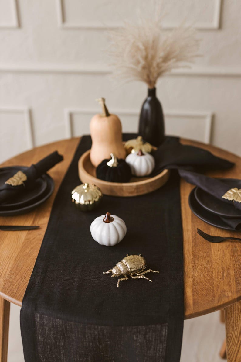 Elegant black natural linen table runner perfect for Halloween, Christmas, and Thanksgiving table settings. Adds a sophisticated, modern touch to weddings or formal dinners. A timeless and luxurious gift idea for housewarming or a new home, blending natural charm with bold, minimal style.
