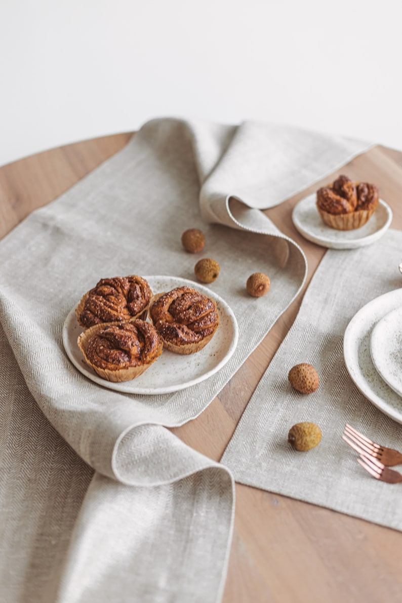 Elegant natural linen table runner in white herringbone, ideal for rustic wedding receptions, Christmas and Thanksgiving Day gatherings, or everyday dining. A soft, minimalist accent that brings warmth and charm to any holiday dinner or celebration. Thoughtfully handmade by Thing Stories.