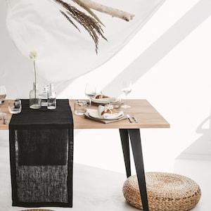 Handmade black linen table runner crafted from natural OEKO-TEX certified fabric. Ideal for cozy, stylish settings during holiday dinners, weddings, or seasonal celebrations. A unique and eco-friendly housewarming gift that adds warmth, texture, and modern elegance to any festive or everyday table.