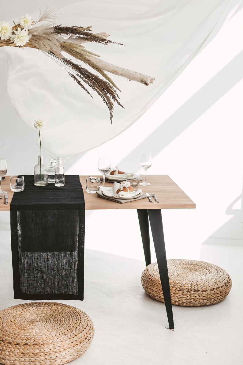 Handmade black linen table runner crafted from natural OEKO-TEX certified fabric. Ideal for cozy, stylish settings during holiday dinners, weddings, or seasonal celebrations. A unique and eco-friendly housewarming gift that adds warmth, texture, and modern elegance to any festive or everyday table.