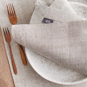 Modern white linen table runner in herringbone pattern, perfect for rustic weddings, Christmas table decor, or a cozy Thanksgiving Day table setting. Handmade from natural linen, it adds elegance to holiday dinners, birthday parties, or Mother's Day brunch. A timeless table accent by Thing Stories.