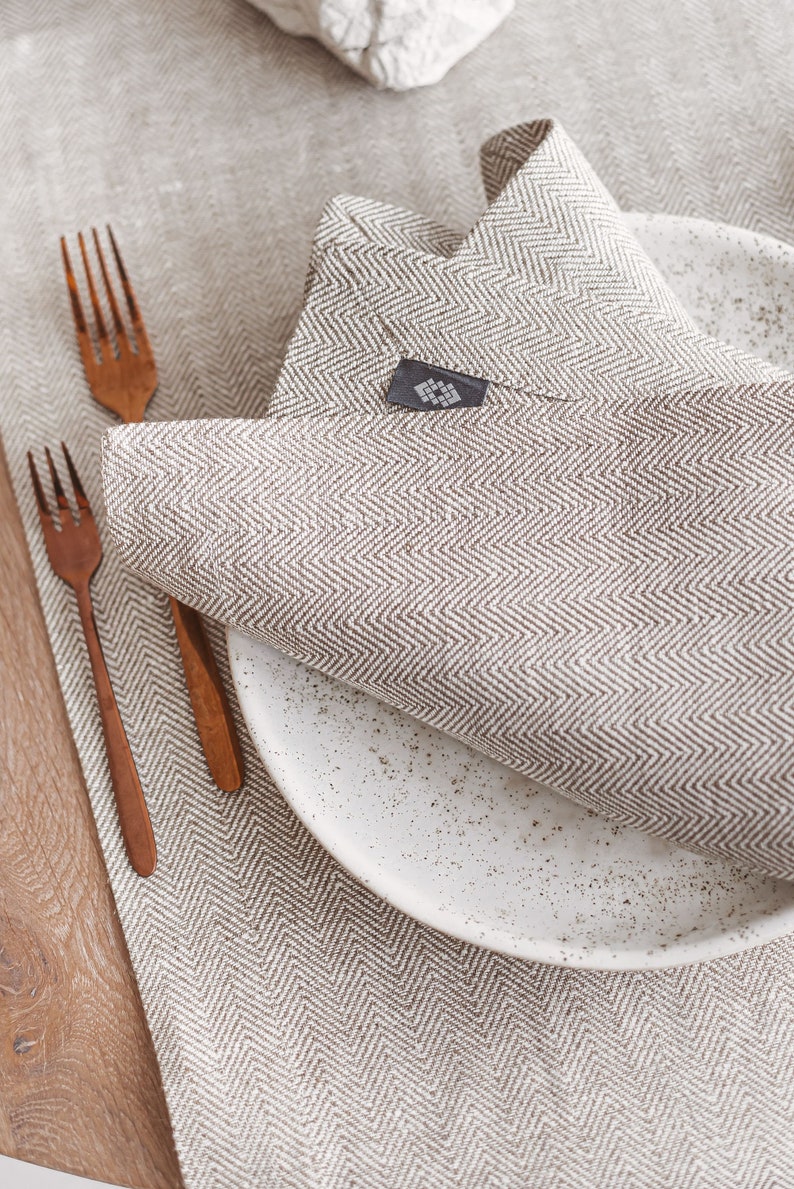 Modern white linen table runner in herringbone pattern, perfect for rustic weddings, Christmas table decor, or a cozy Thanksgiving Day table setting. Handmade from natural linen, it adds elegance to holiday dinners, birthday parties, or Mother's Day brunch. A timeless table accent by Thing Stories.