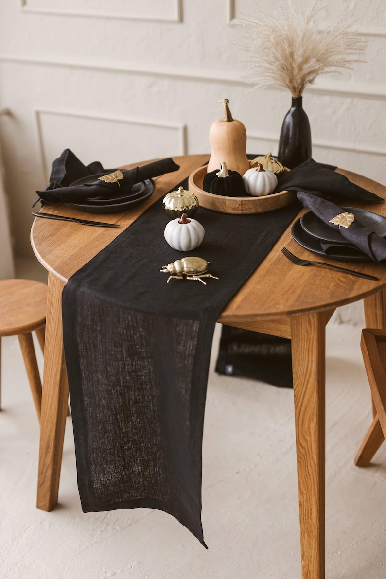 Elegant black natural linen table runner perfect for Halloween, Christmas, and Thanksgiving table settings. Adds a sophisticated, modern touch to weddings or formal dinners. A timeless and luxurious gift idea for housewarming or a new home, blending natural charm with bold, minimal style.