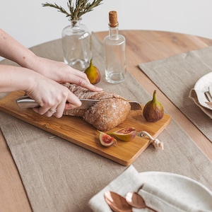 Handmade natural linen table runner from Thing Stories, ideal for creating a warm, rustic wedding atmosphere or dressing up your table for Christmas, Thanksgiving, or any holiday dinner. A minimalist, earthy choice for birthdays, Mother's Day, and everyday gatherings.