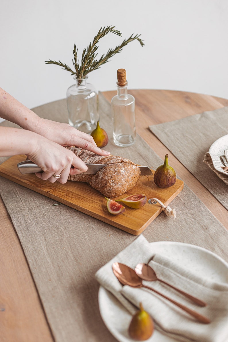 Handmade natural linen table runner from Thing Stories, ideal for creating a warm, rustic wedding atmosphere or dressing up your table for Christmas, Thanksgiving, or any holiday dinner. A minimalist, earthy choice for birthdays, Mother's Day, and everyday gatherings.