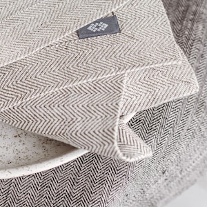 Handmade herringbone grey table runner and herringbone white placemat from a close view