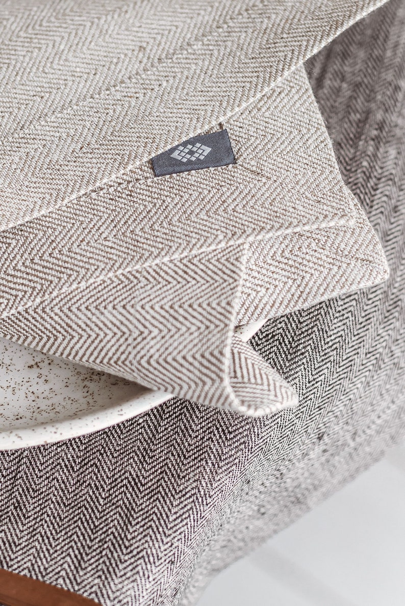 Handmade herringbone grey table runner and herringbone white placemat from a close view