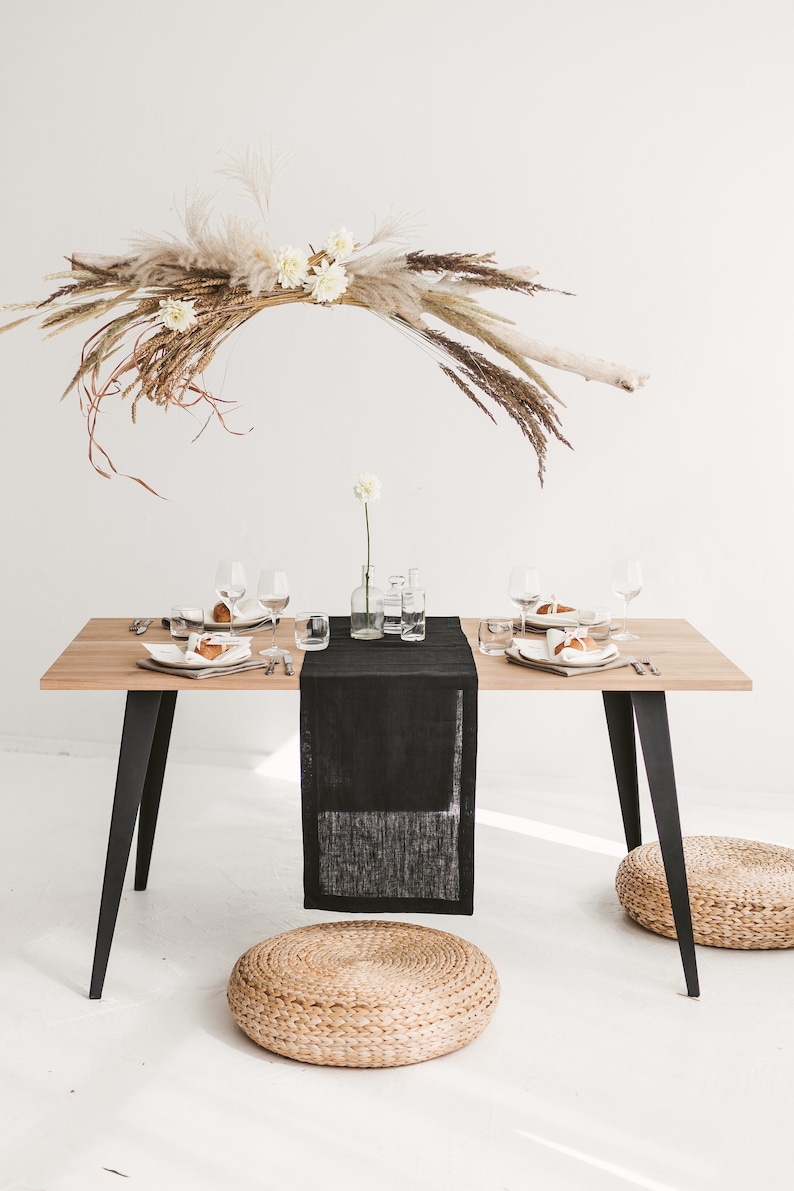 Handmade black linen table runner crafted from natural OEKO-TEX certified fabric. Ideal for cozy, stylish settings during holiday dinners, weddings, or seasonal celebrations. A unique and eco-friendly housewarming gift that adds warmth, texture, and modern elegance to any festive or everyday table.