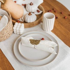 This elegant white linen table runner makes a perfect housewarming gift or timeless addition to a modern, minimalist kitchen or dining room.