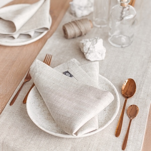 White herringbone linen table runner from Thing Stories – the perfect touch for a rustic wedding, Mother's Day, or festive Christmas table decor. Made of high-quality natural linen, it complements Thanksgiving Day table settings and birthday celebrations with simple, modern elegance.