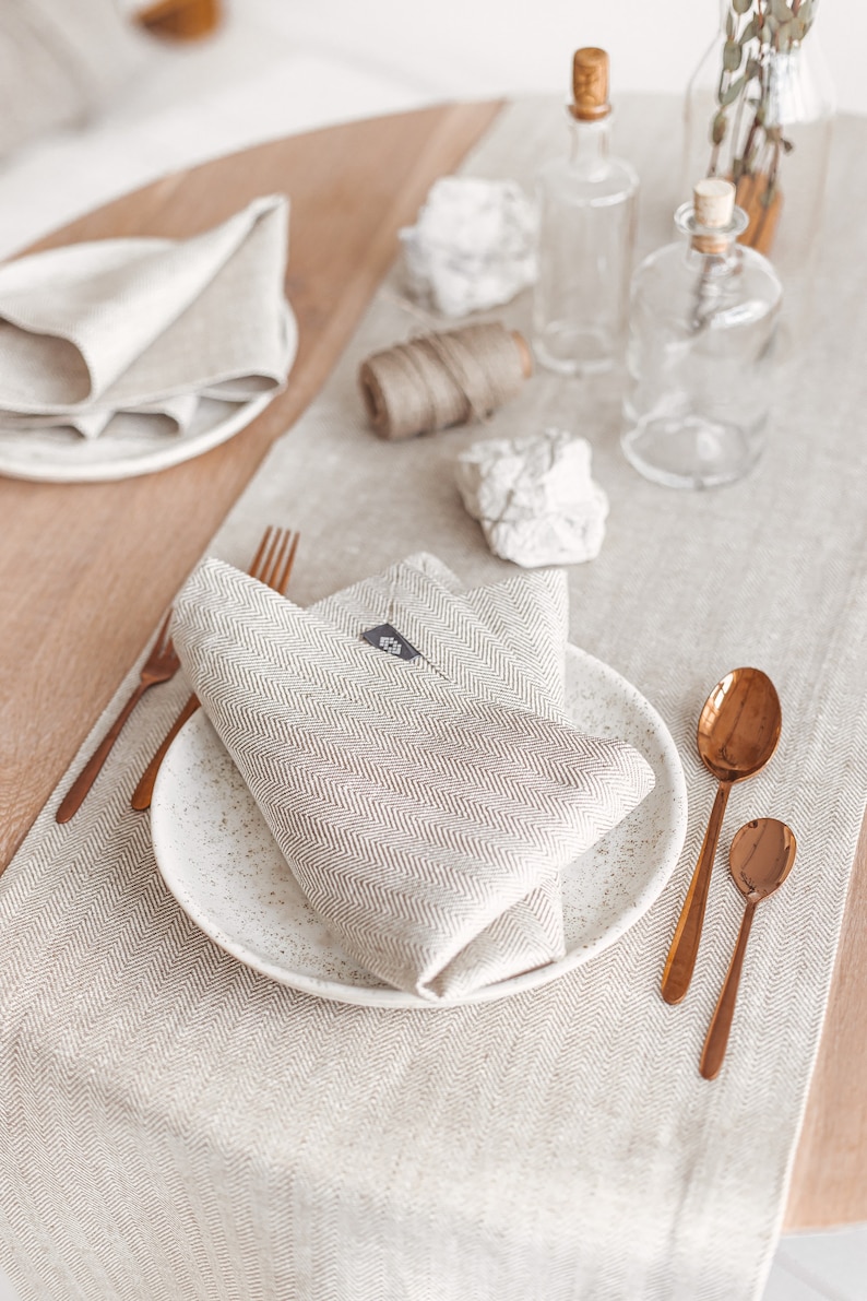 White herringbone linen table runner from Thing Stories – the perfect touch for a rustic wedding, Mother's Day, or festive Christmas table decor. Made of high-quality natural linen, it complements Thanksgiving Day table settings and birthday celebrations with simple, modern elegance.