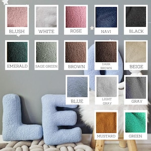 May include: A collection of 15 plush fabric swatches in various colors, including blush, white, rose, navy, black, emerald, sage green, brown, dark brown, beige, blue, light gray, gray, mustard, and green. The swatches are arranged in a grid pattern and are labeled with their corresponding colors.